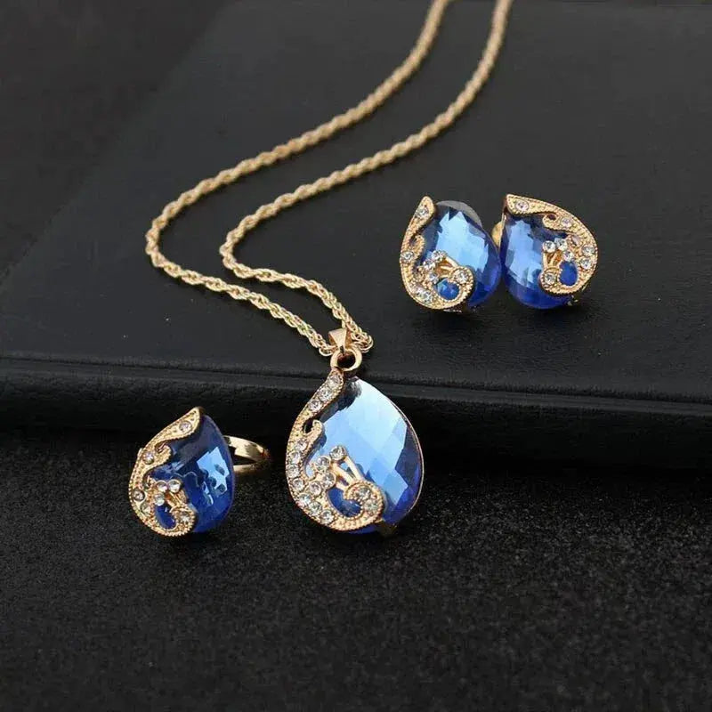 Set med halsband och örhängen i blå kristall med guldfinish