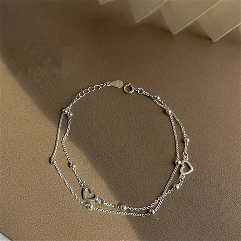 Justerbart silverarmband med hjärtformat hänge