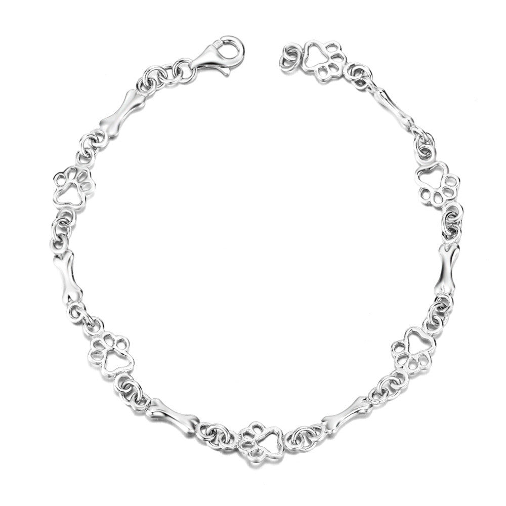 Armband i begränsad upplaga med berlocker i massivt silver formade som hundtass och ben