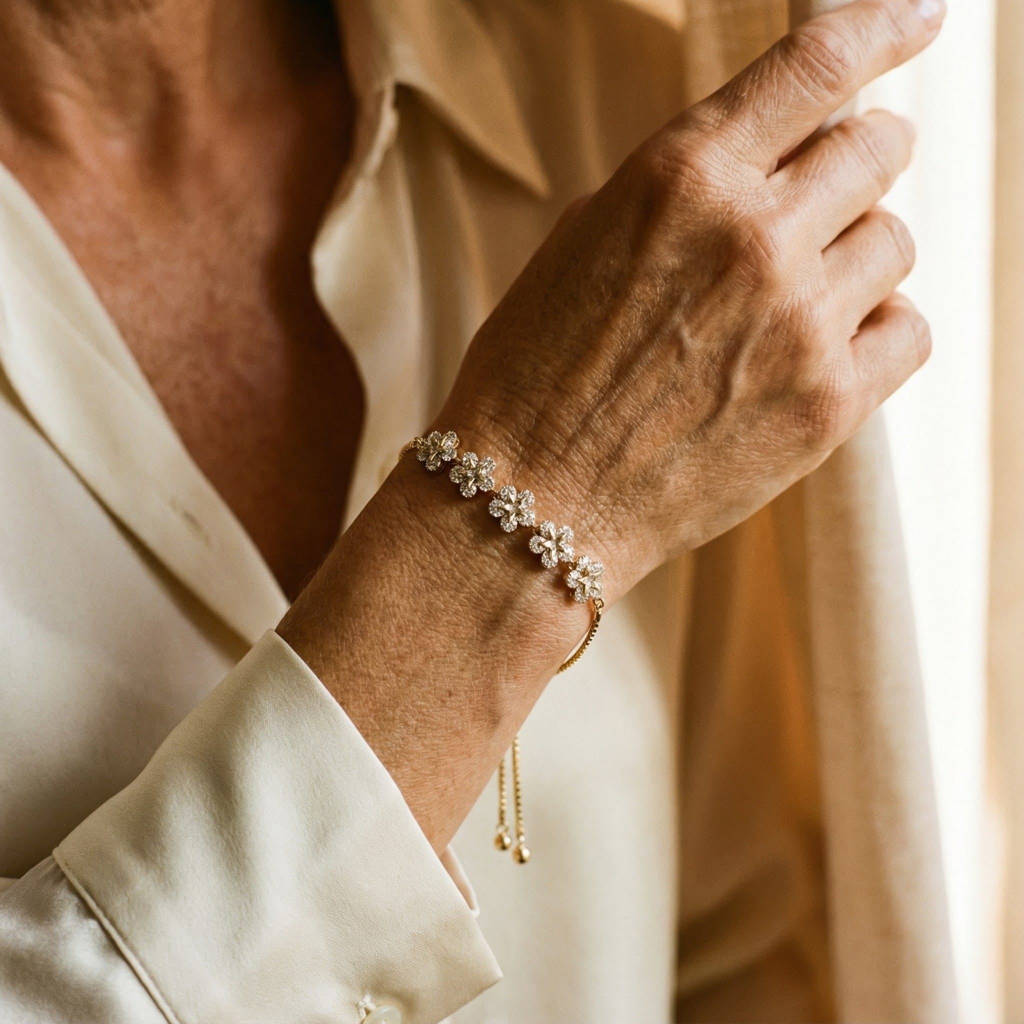 Guldfärgat armband med prästkragar och kristaller