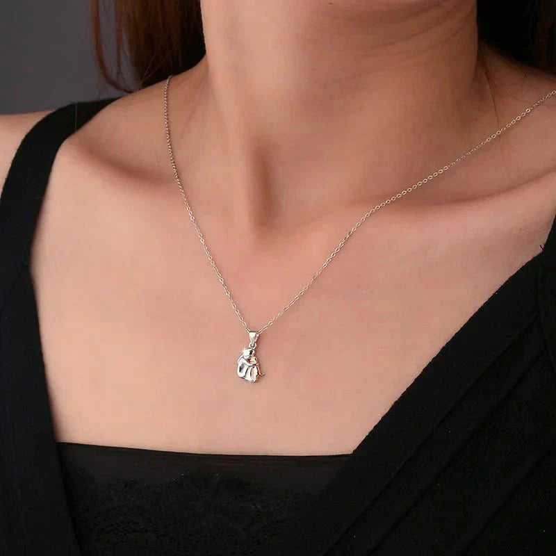Halsband med hänge “Omfamning” och matchande örhängen